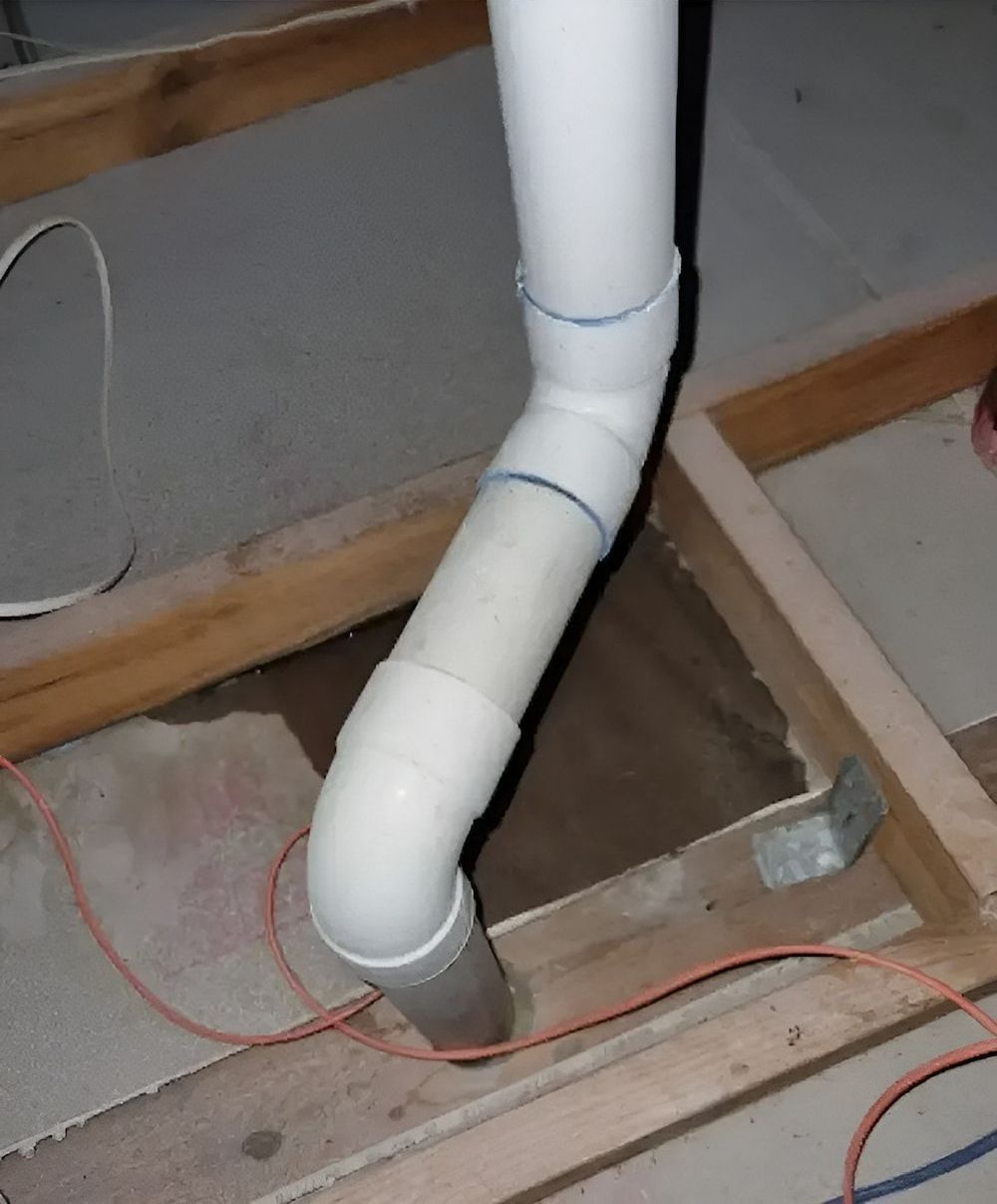 A White Pipe Is Connected To A Wooden Frame — Salt Building & Pest Inspections in Currumbin, QLD
