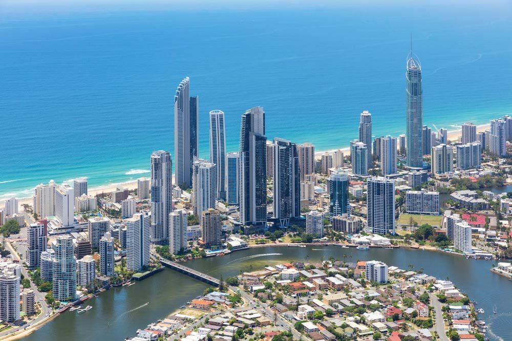 An Aerial View Of A City Surrounded By Water And Buildings — Salt Building & Pest Inspections in Broadbeach, QLD