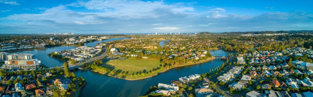 An Aerial View Of A City With A River Running Through It — Salt Building & Pest Inspections in Reedy Creek, QLD