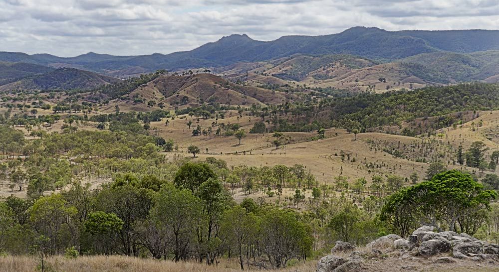 A Landscape With Mountains In The Background And Trees In The Foreground — Salt Building & Pest Inspections in Tallai, QLD