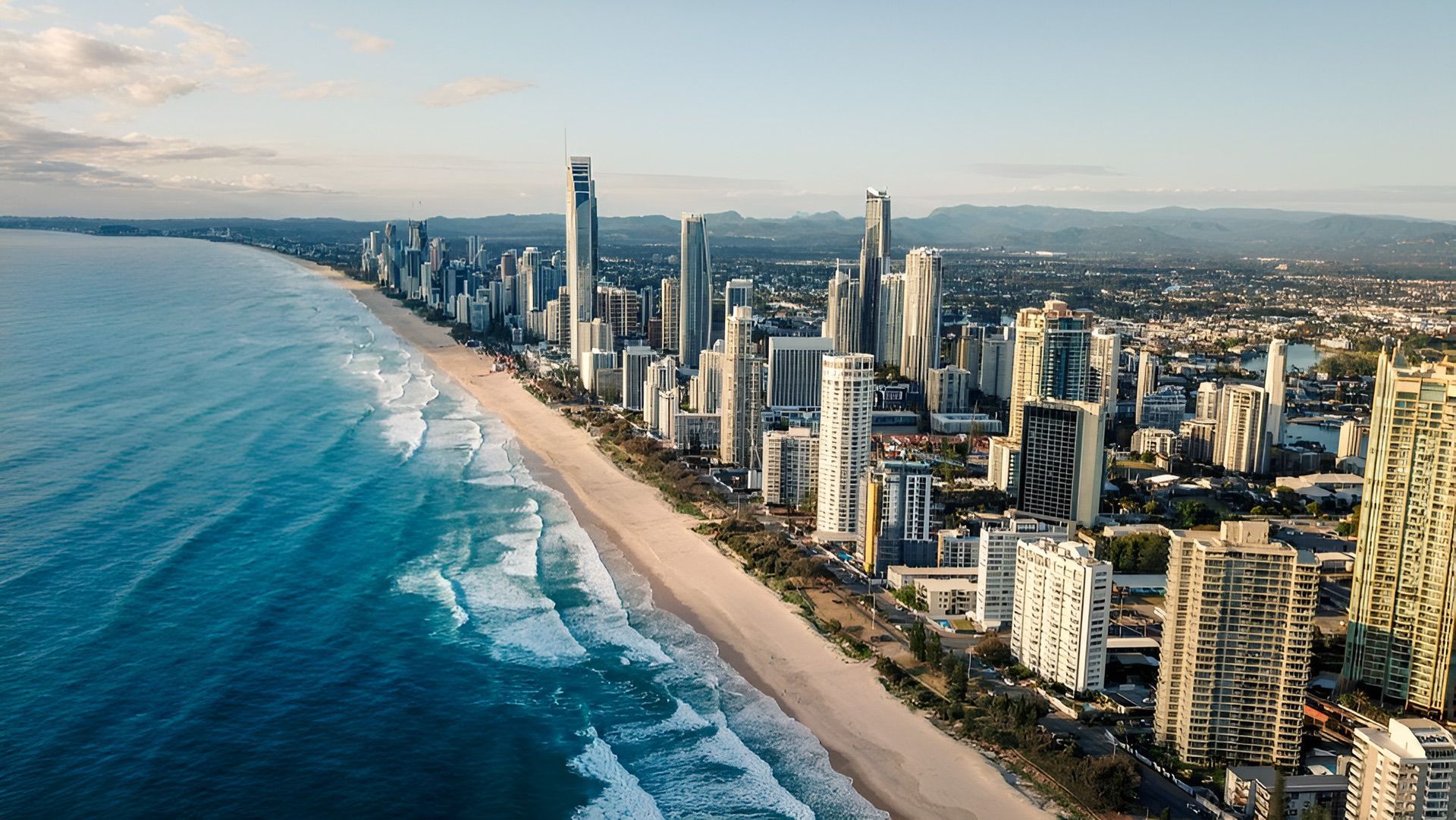 A Man Wearing A Mask Is Spraying A Wall With A Sprayer — Salt Building & Pest Inspections in Banora Point, NSW