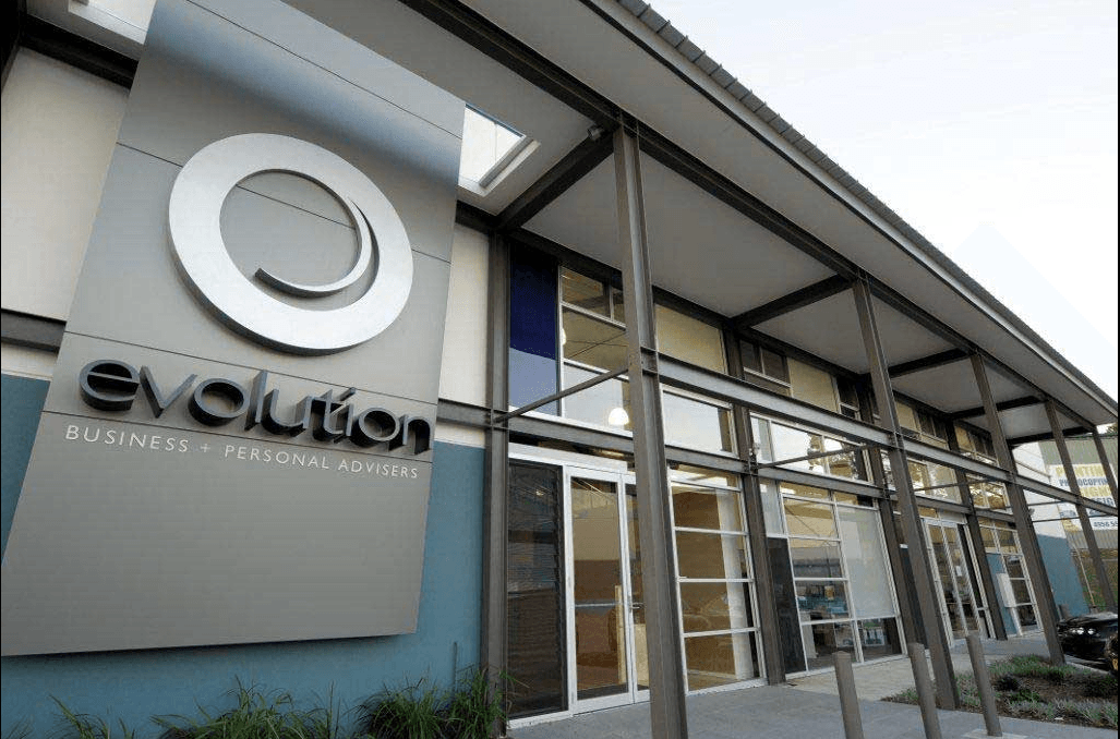 A Building With a Sign That Says Evolution on It — Kymar Steel Fabrications in Teralba, NSW