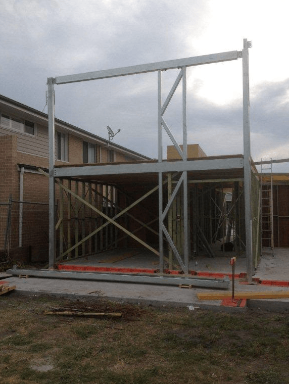 A House Under Construction With a Satellite Dish on Top of It — Kymar Steel Fabrications in Teralba, NSW