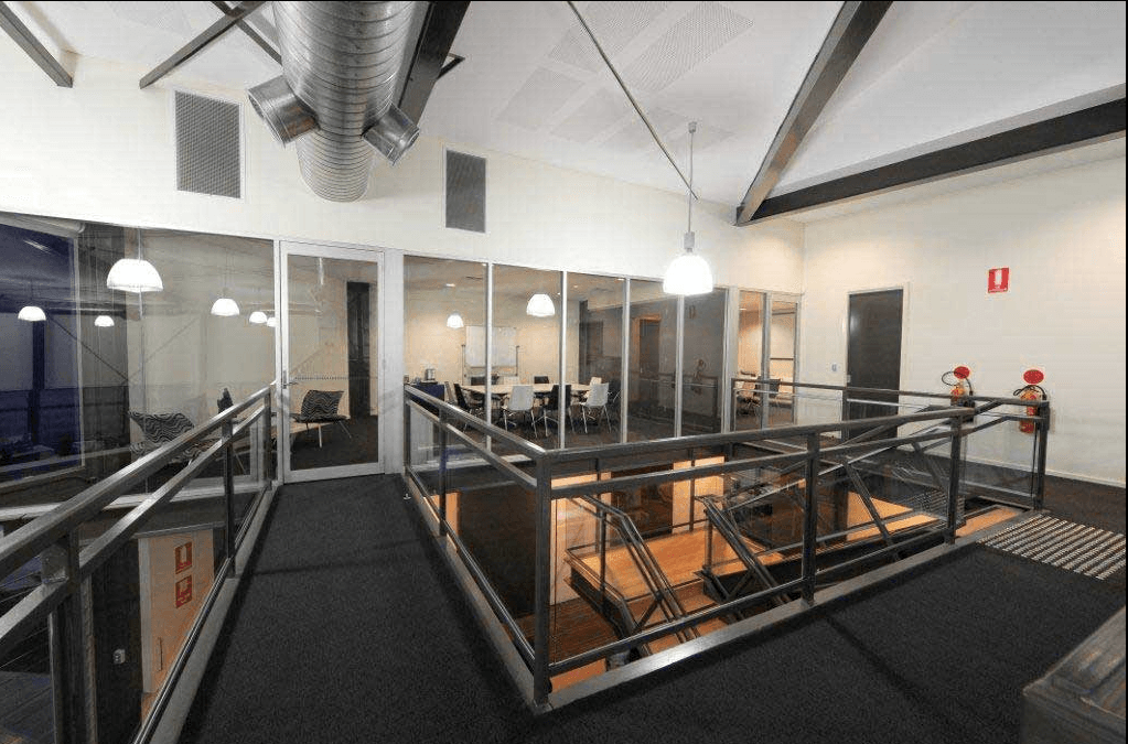 A Hallway With a Staircase Leading Up to the Second Floor — Kymar Steel Fabrications in Teralba, NSW