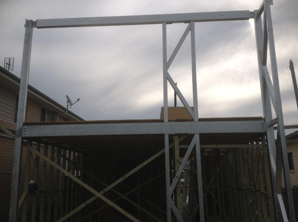 A Large Metal Structure With a Wooden Deck Underneath It — Kymar Steel Fabrications in Teralba, NSW