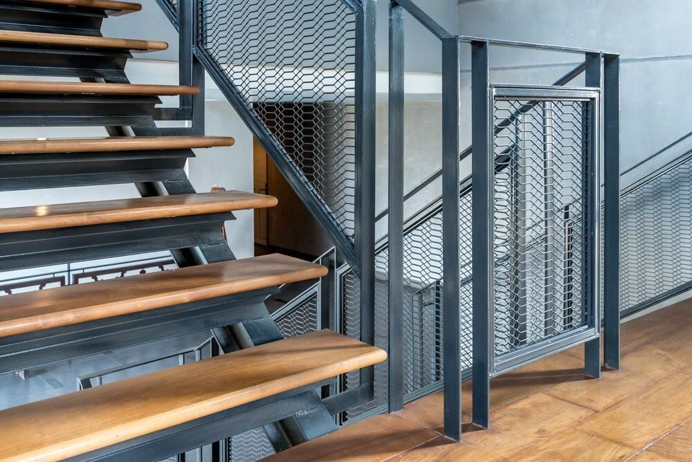 A Staircase With Wooden Steps and a Metal Railing — Kymar Steel Fabrications in Newcastle, NSW