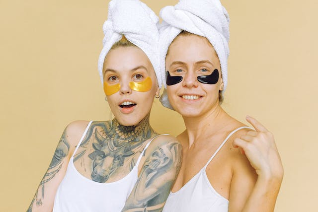 Two Women with Towels Wrapped Around Their Heads and Eye Patches on Their Faces — Rejuved in Bateau Bay, NSW