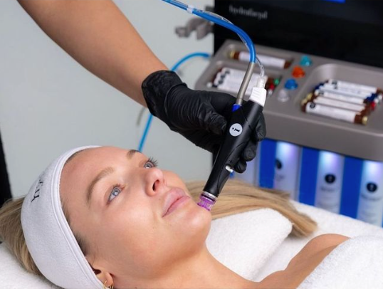 A Woman Is Getting a Facial Treatment at A Beauty Salon — Rejuved in Bateau Bay, NSW