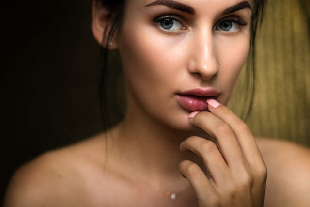 A Close up Of a Woman 's Face with Her Hand on Her Lips — Rejuved in Bateau Bay, NSW