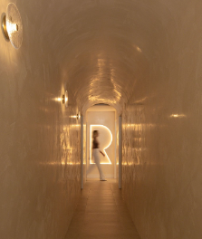 A Person Is Walking Down a Hallway with A Light on The Wall — Rejuved in Bateau Bay, NSW