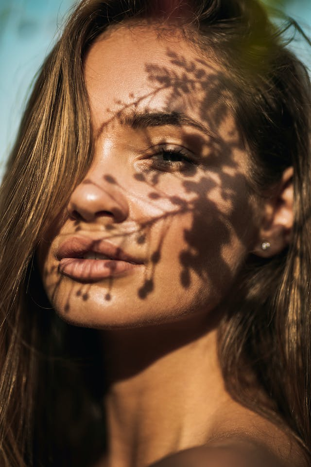 A Close up Of a Woman 's Face with A Tree Shadow on It — Rejuved in Bateau Bay, NSW