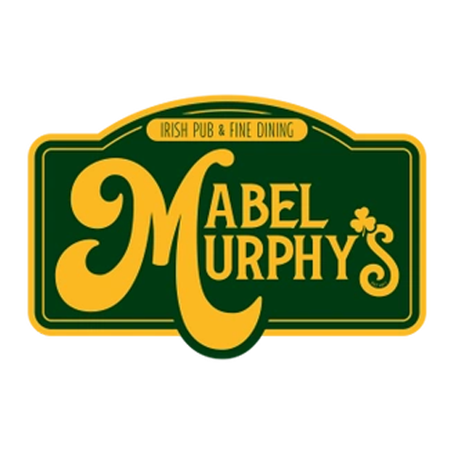 Burger with fries on a plate; burger has bacon, lettuce, and sauce, fries golden, small dipping sauces.