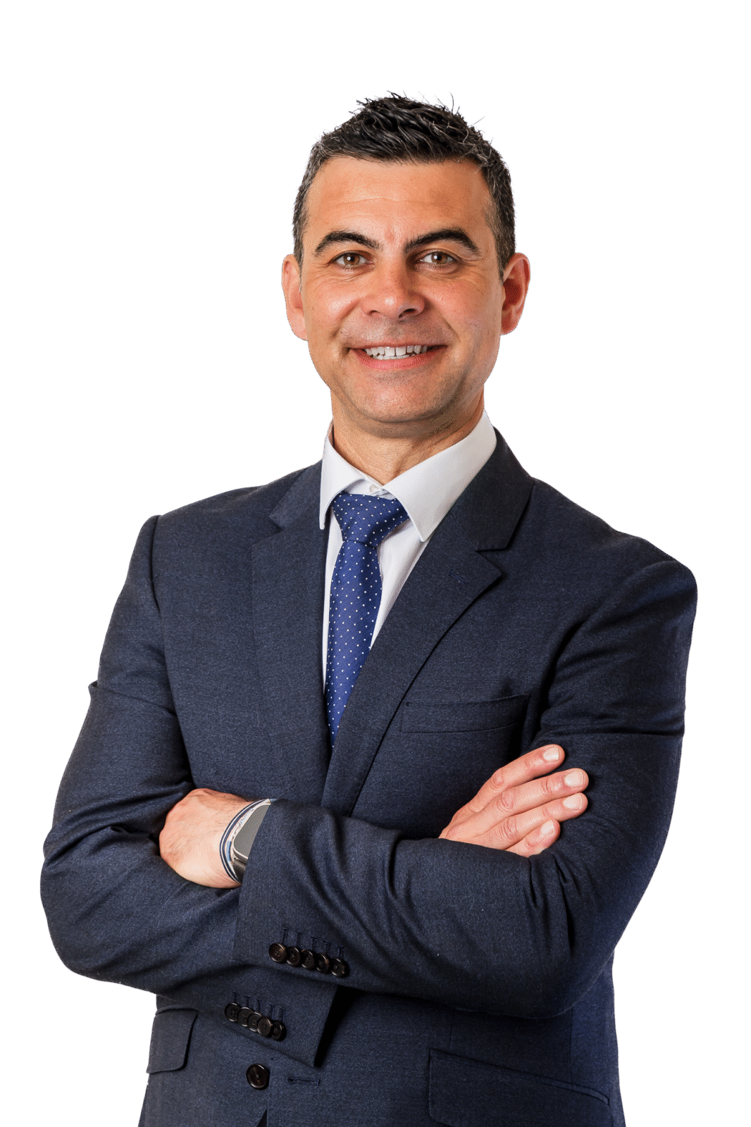 A man in a suit and tie is standing with his arms crossed.