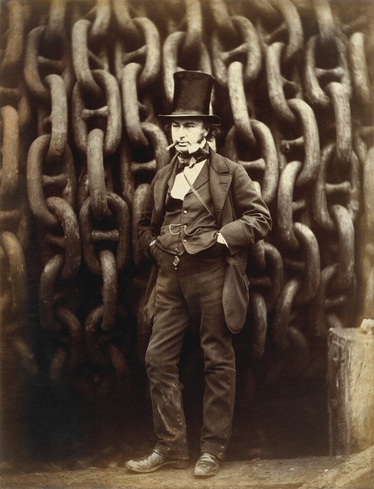 A man in a top hat is standing in front of a wall of chains.