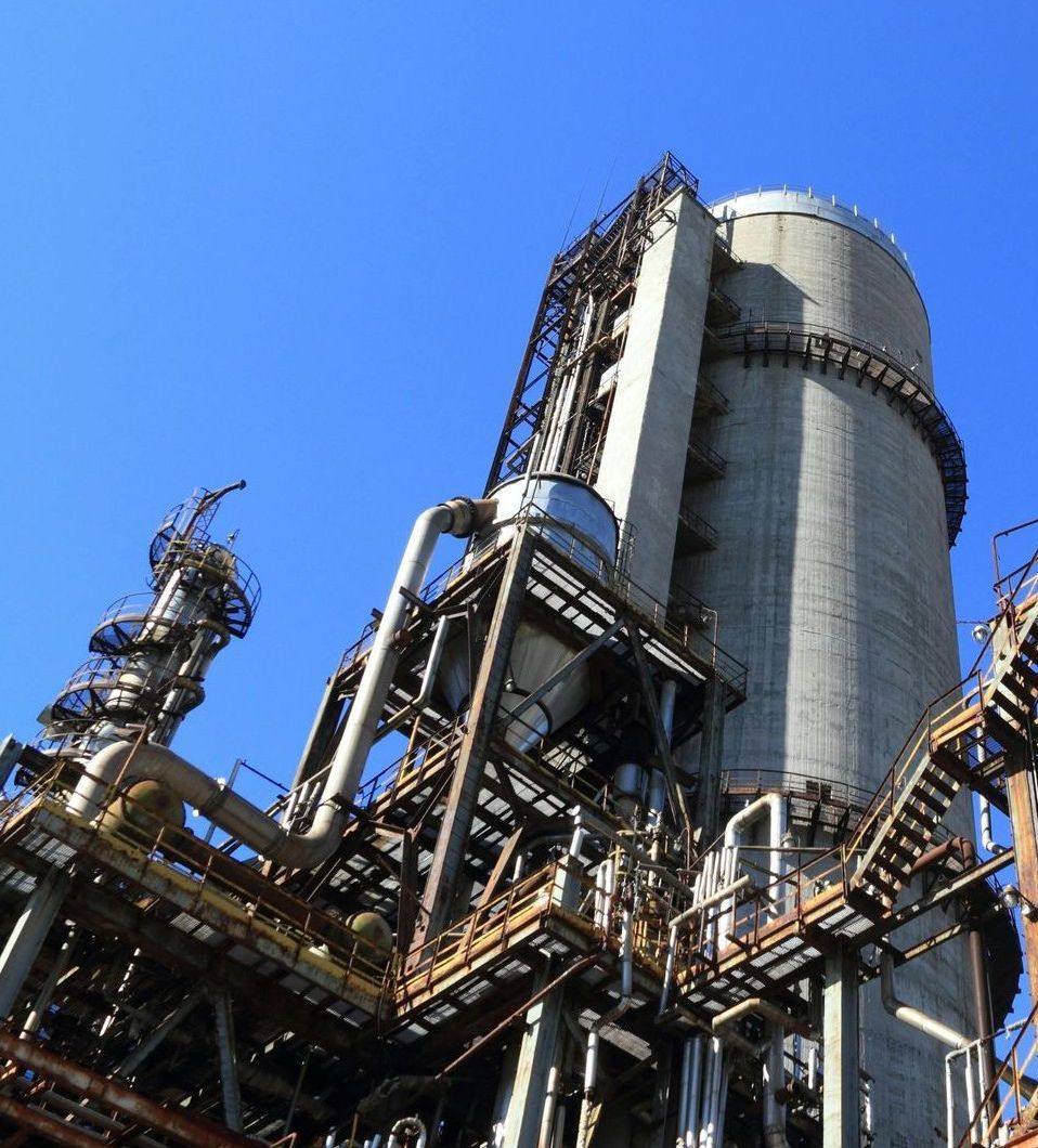A large industrial building with a blue sky in the background