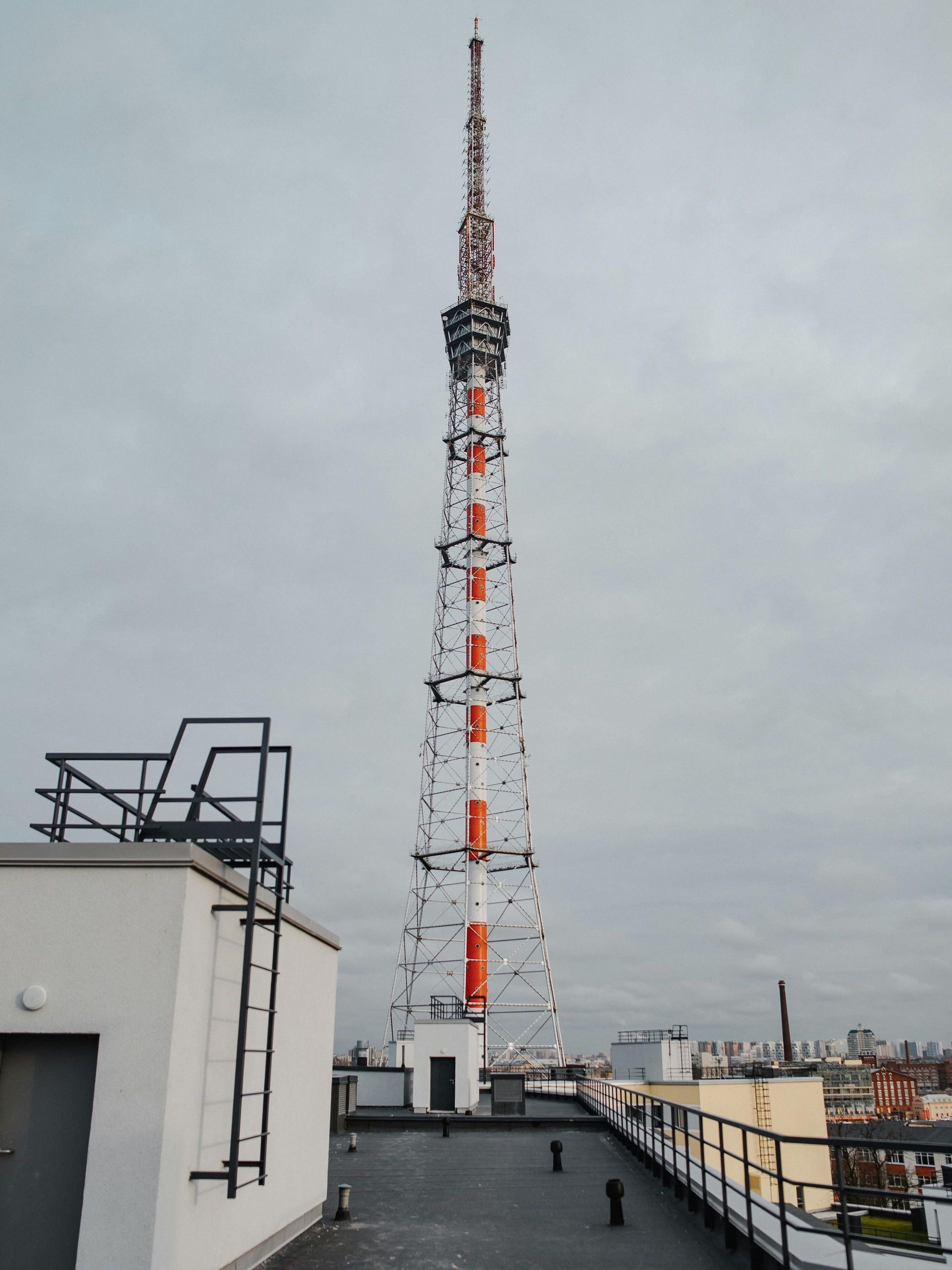A very tall tower is visible from the roof of a building