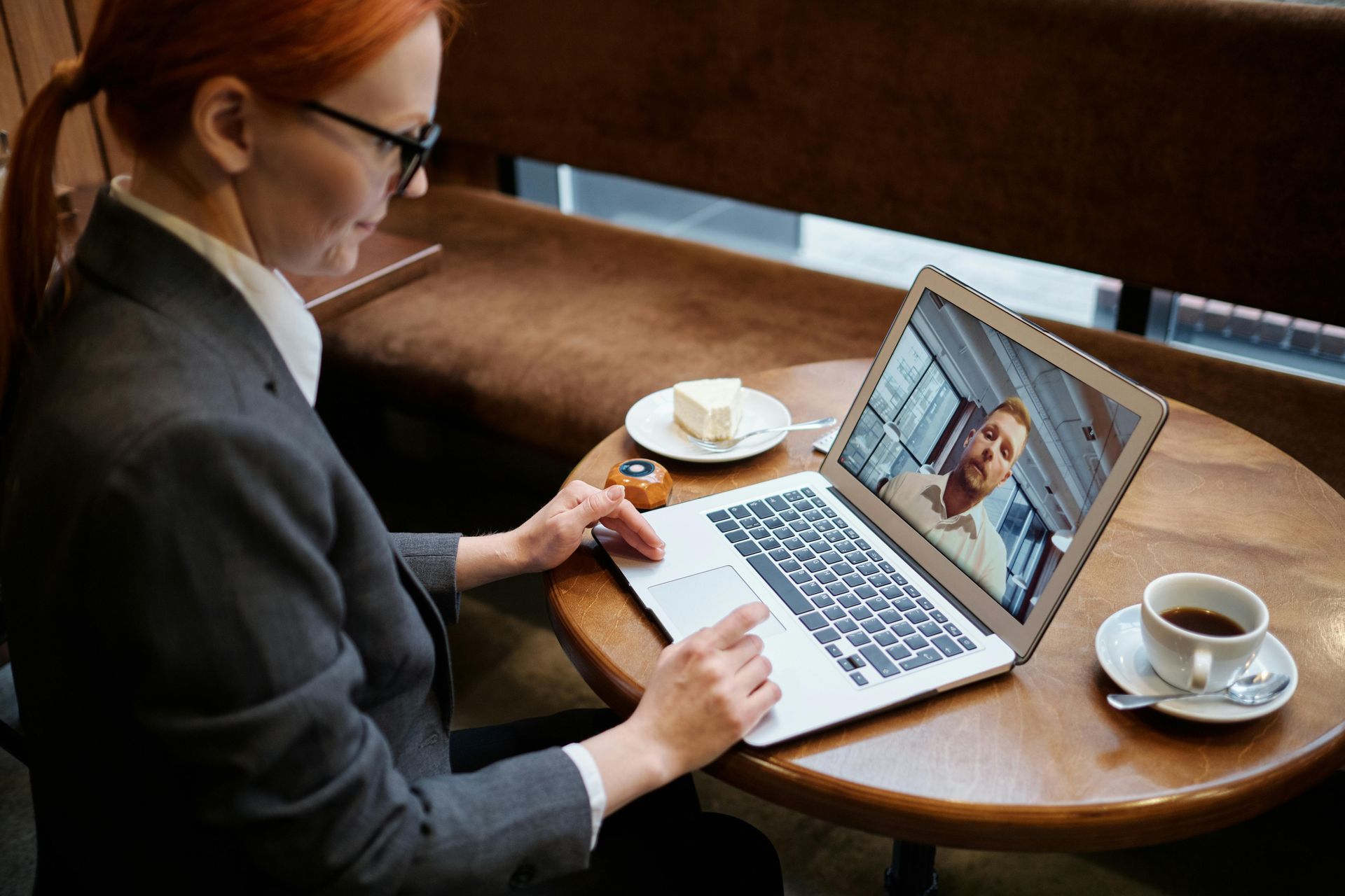 A group of people are sitting around a conference table having a meeting.