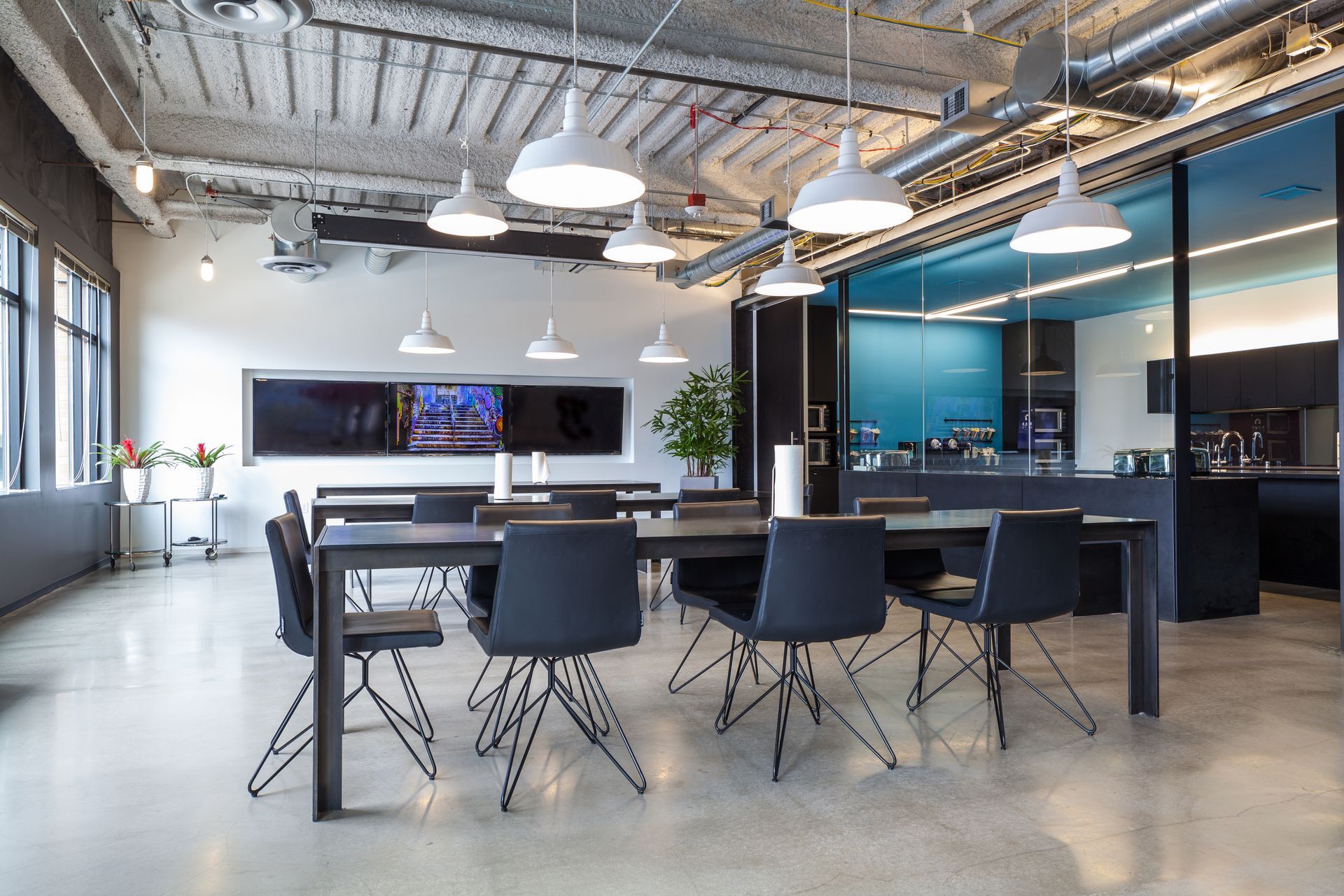 A man wearing a helmet and a gas mask is painting a wall.