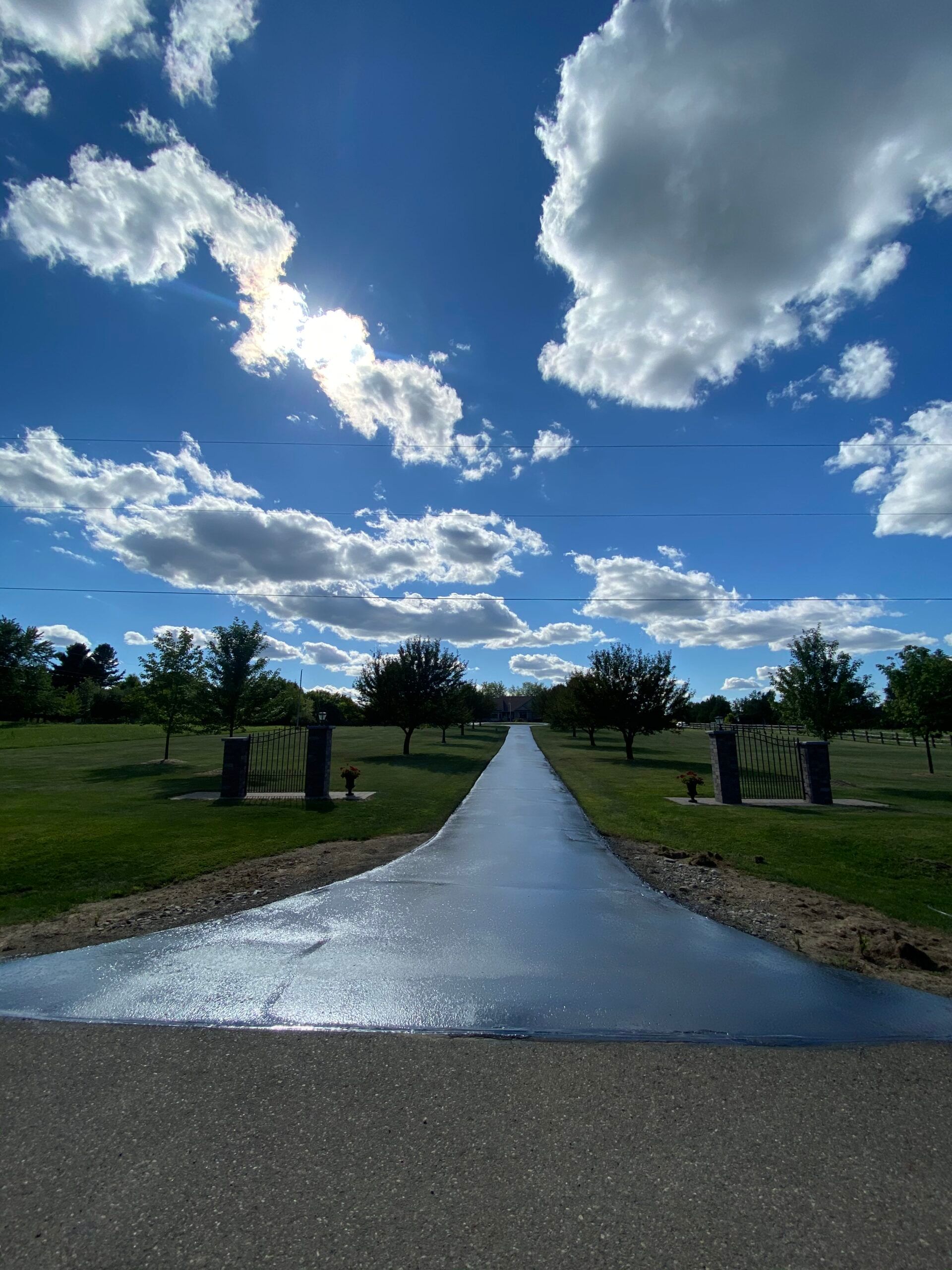 A road with a blue sky and white clouds