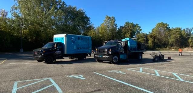 Two trucks are parked in a parking lot.