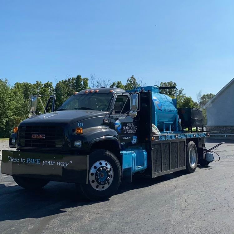 A gmc truck is parked in a parking lot