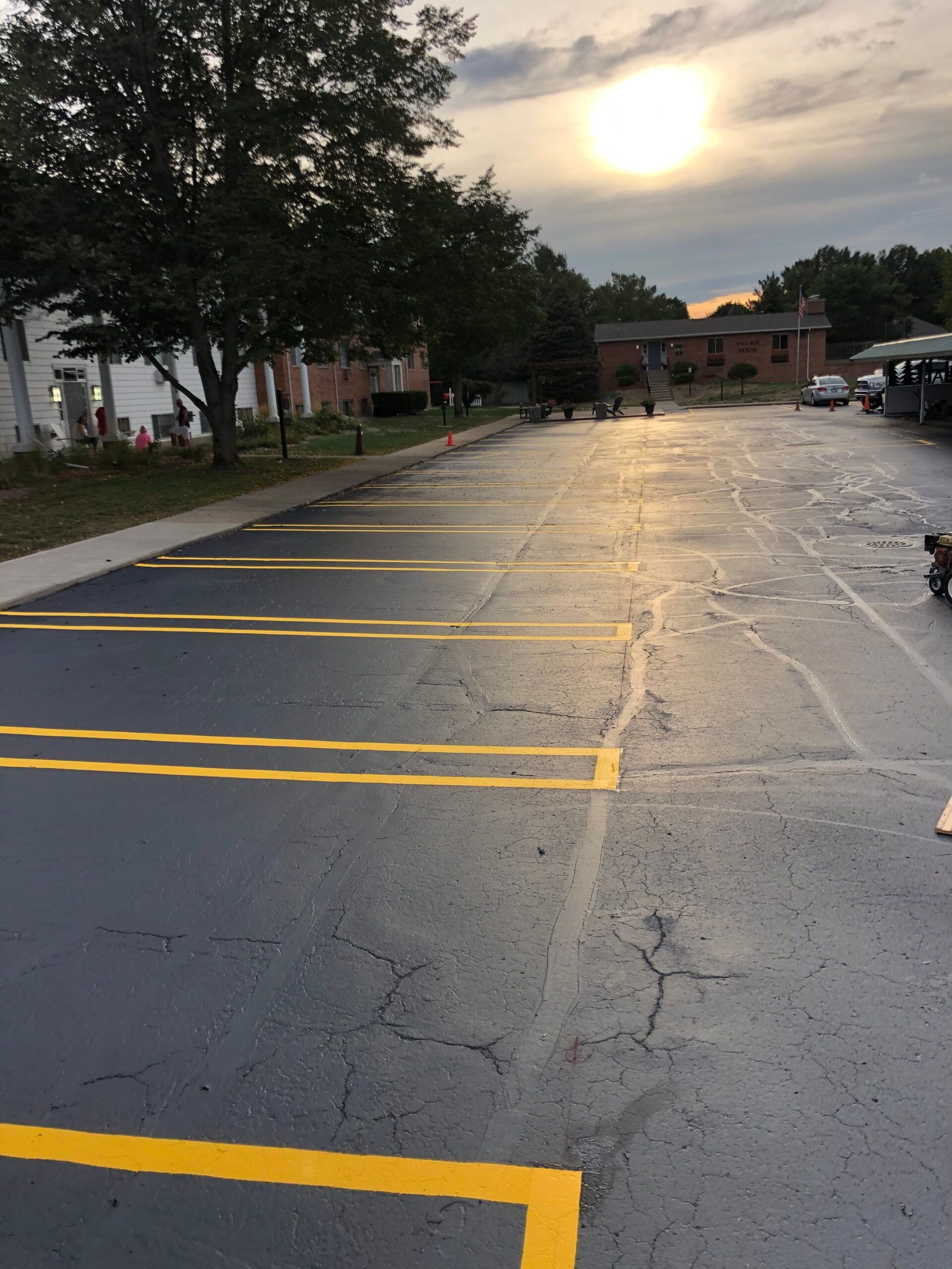 A parking lot with the sun shining through the clouds