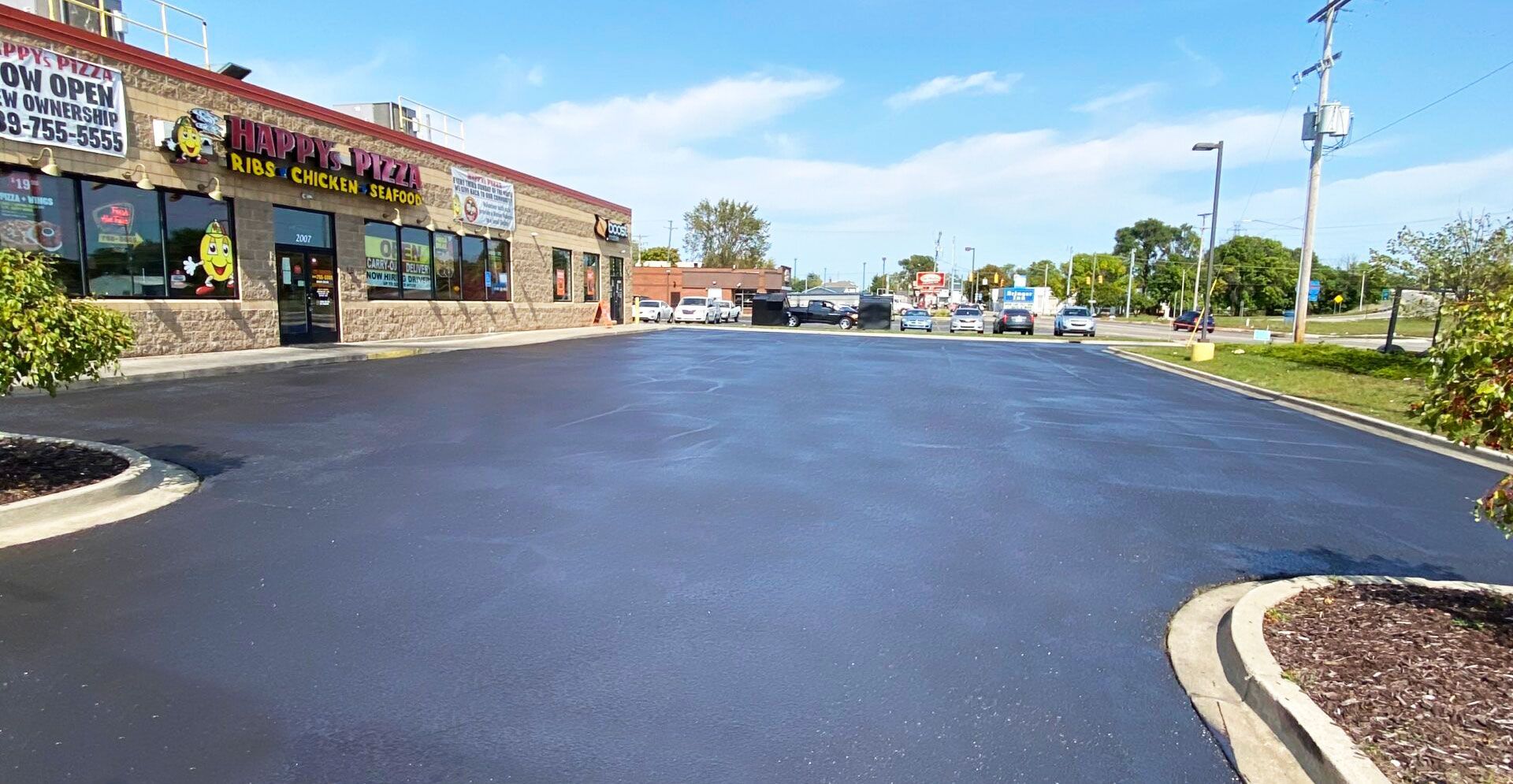 A parking lot in front of a building with a lot of cars parked in it.