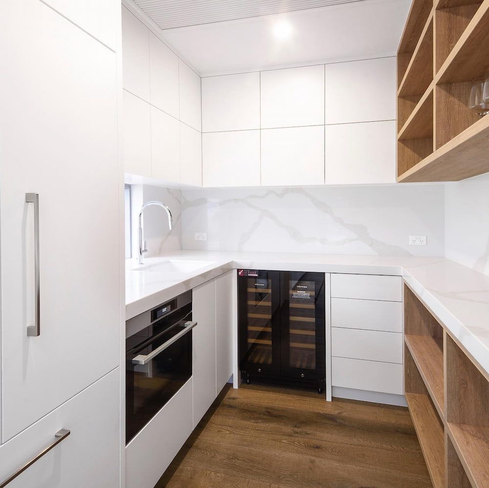 A Kitchen With White Cabinets And A Wine Cooler — Cross Cabinets In Chevallum, QLD