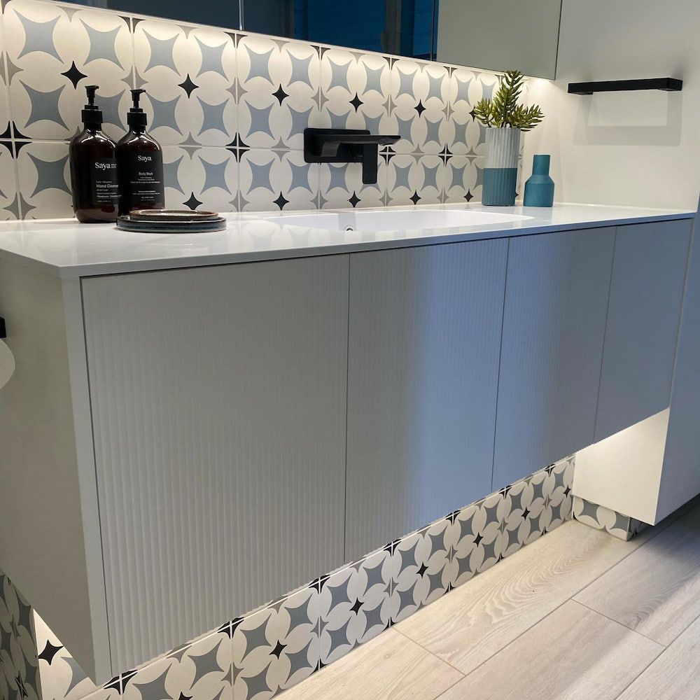 A Bathroom With A Sink And Two Bottles Of Soap On The Counter — Cross Cabinets In Chevallum, QLD