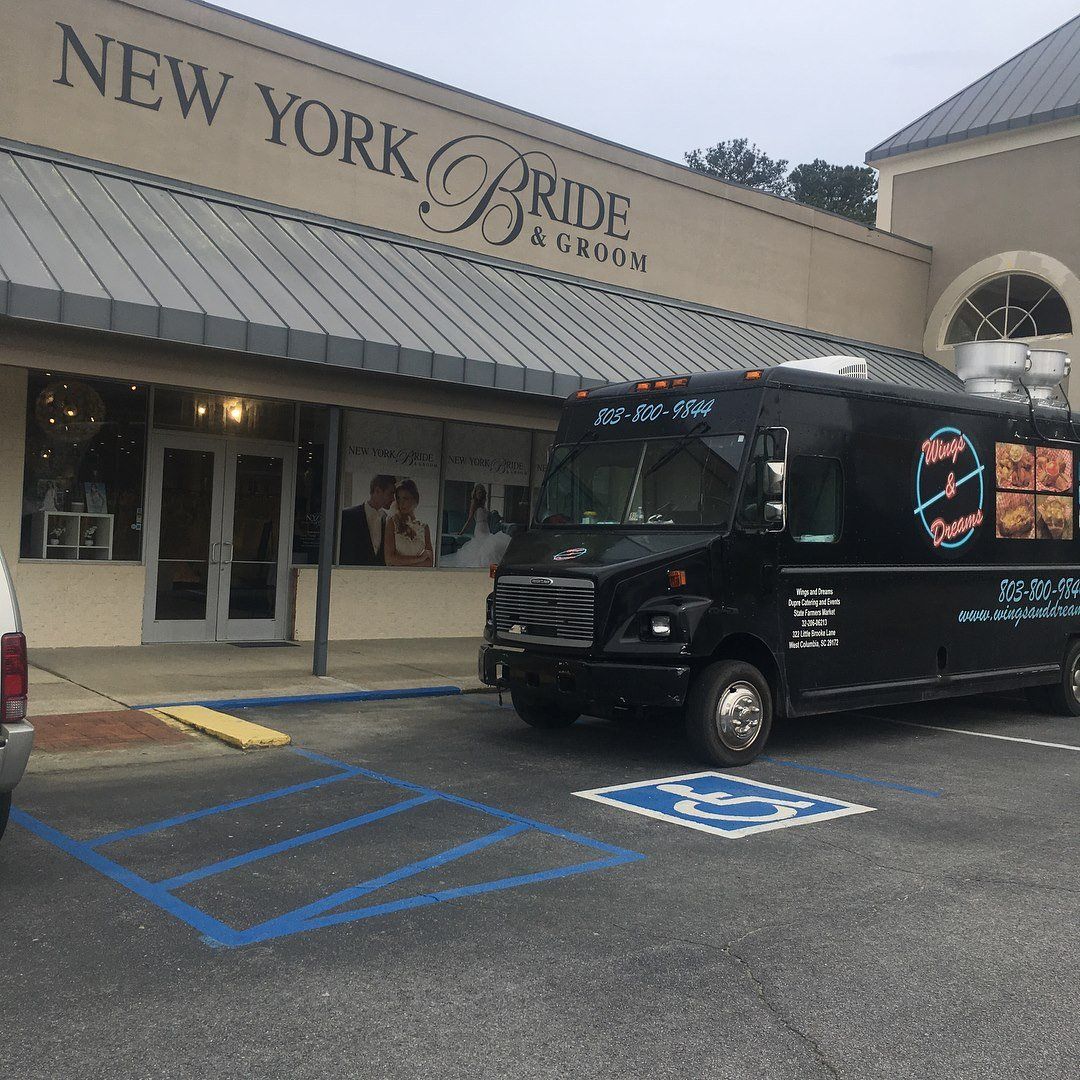 A black food truck parked in front of 