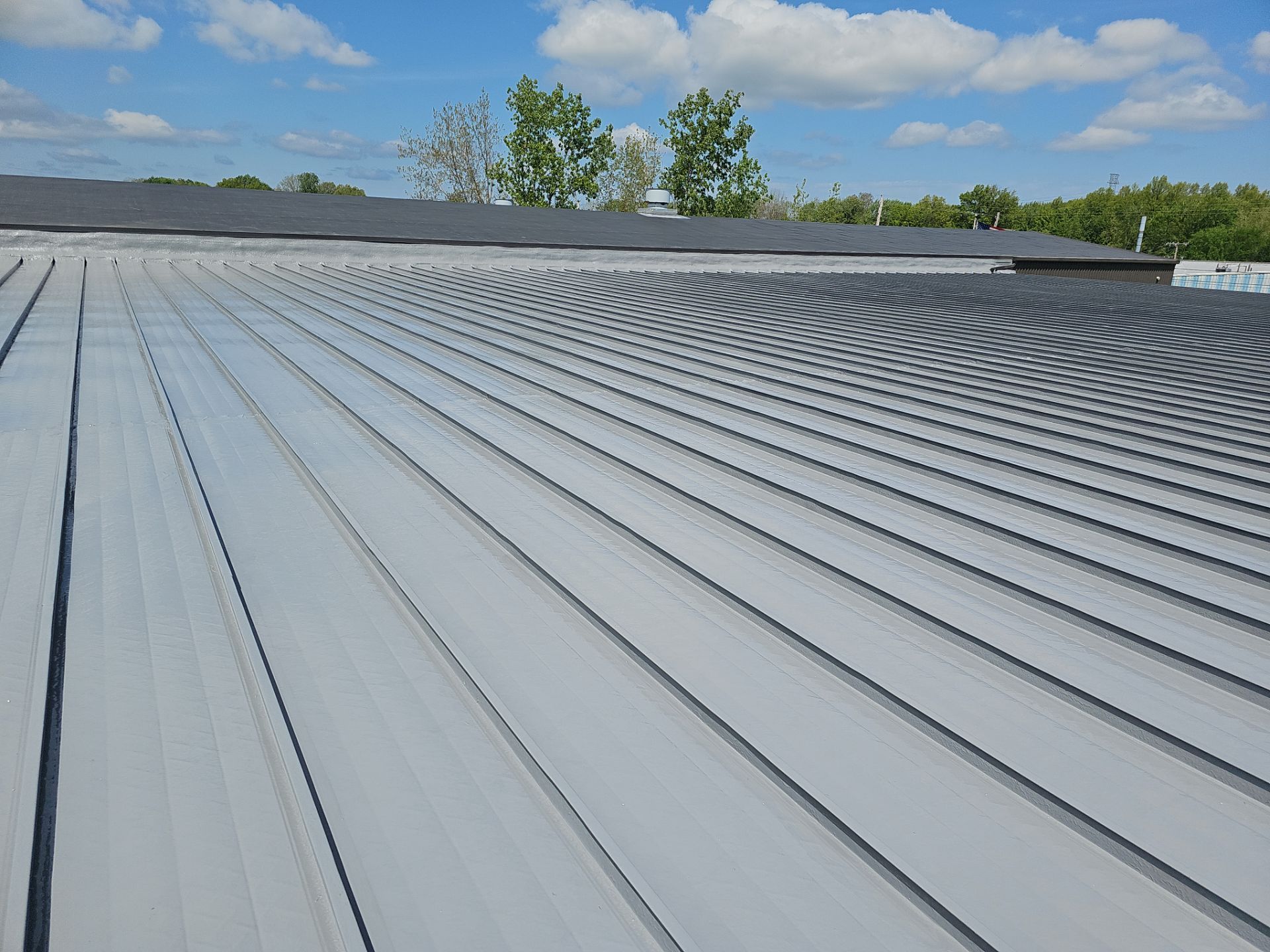 roof coating system installed over a metal roof in Elyria Ohio