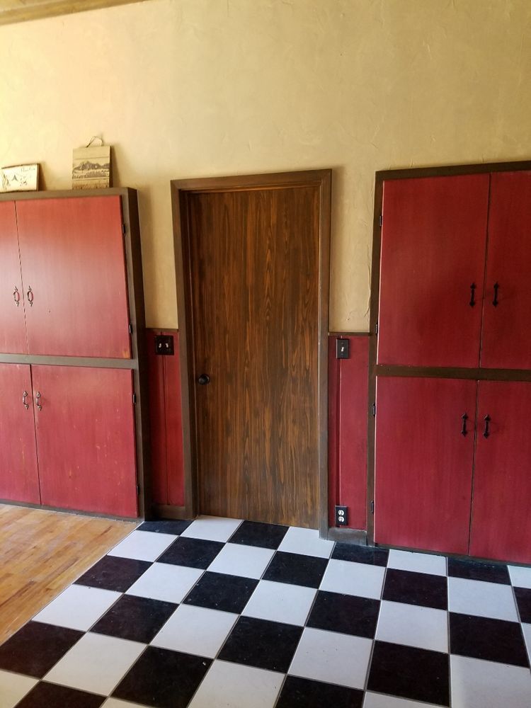 A room with red cabinets and a checkered floor