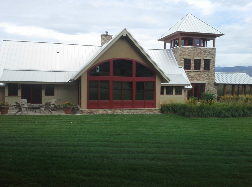 A large house with a large lawn in front of it