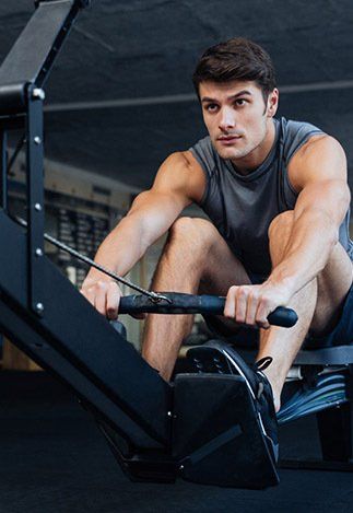 Man Using Rowing Machine — Fitness Trainer in Brisbane, QLD