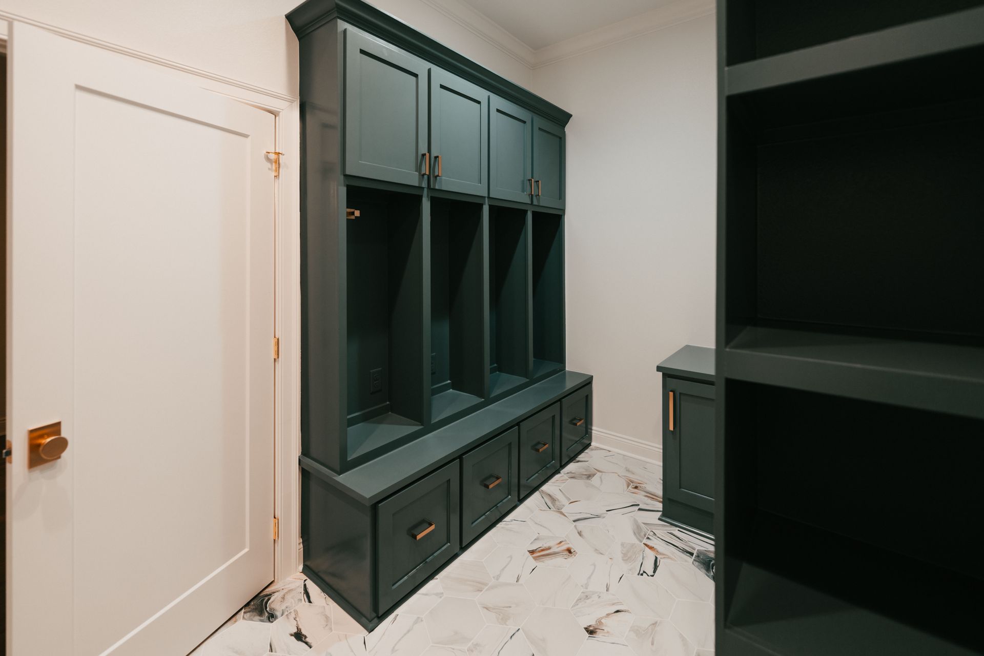 A custom mudroom with dark cabinets, cubbies, and bench seating, offering plenty of storage and organization.