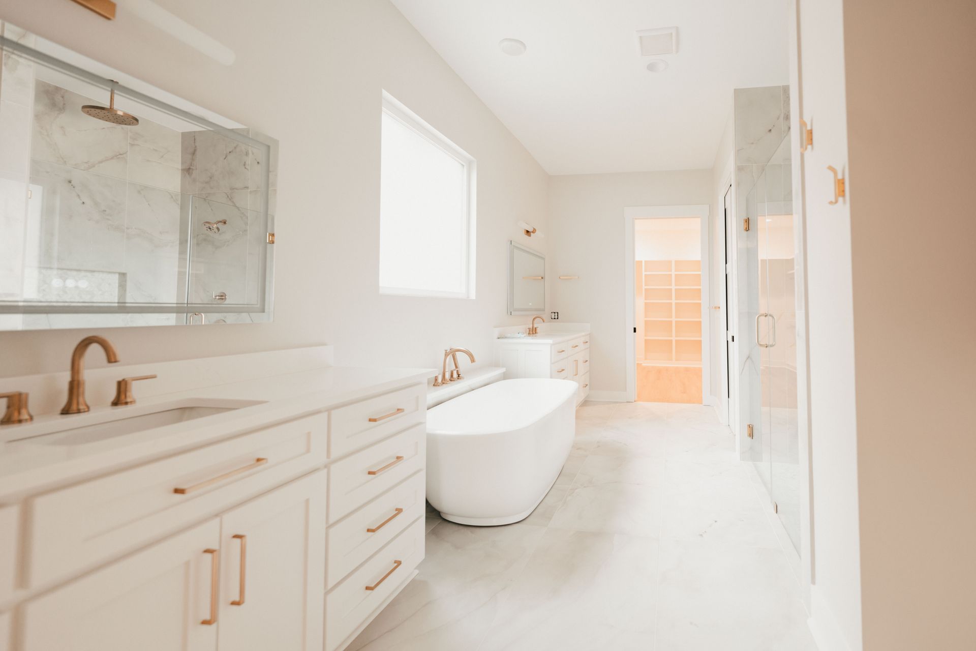 Luxurious bathroom with a freestanding tub, dual sinks, and marble accents.