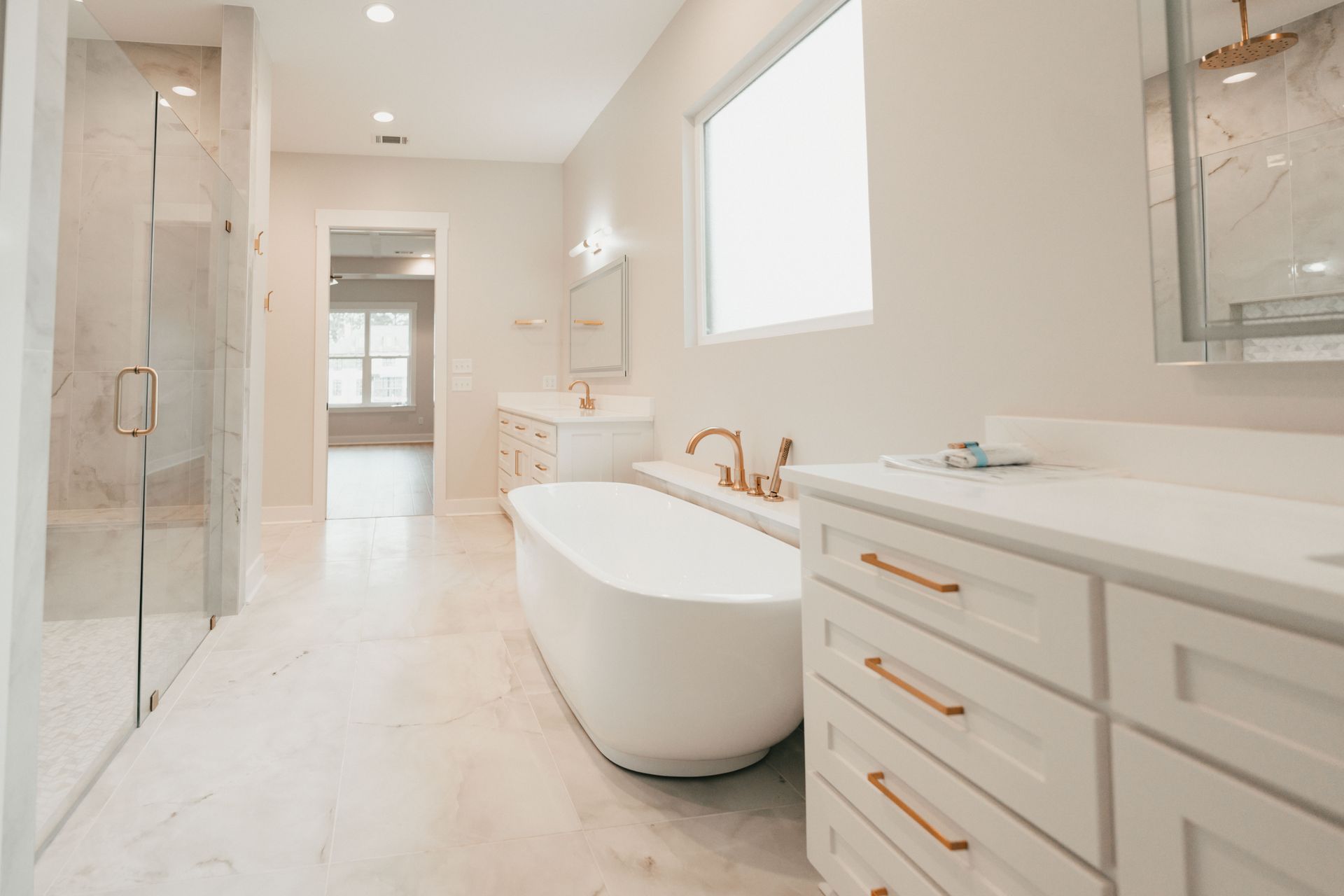 A spacious bathroom with a freestanding tub, shower, and dual vanity sinks.