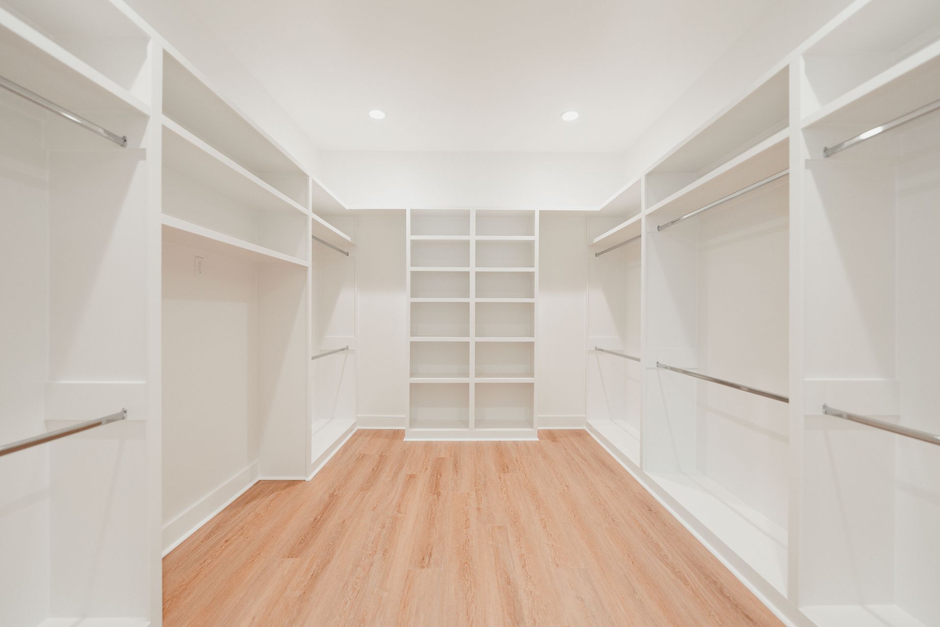 Large walk-in closet with built-in shelving and storage solutions.
