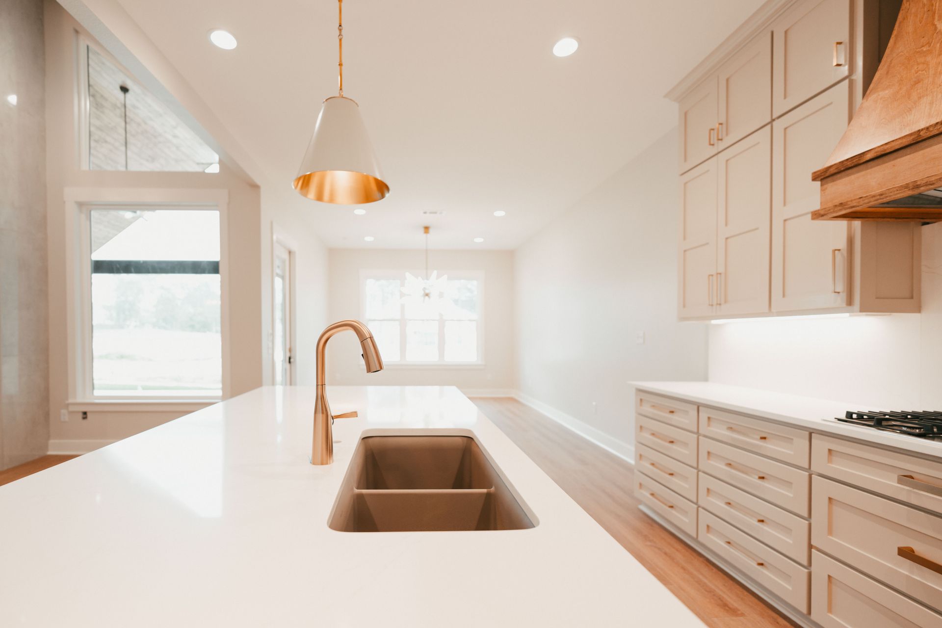 A bright kitchen with a long center island and natural wood accents.