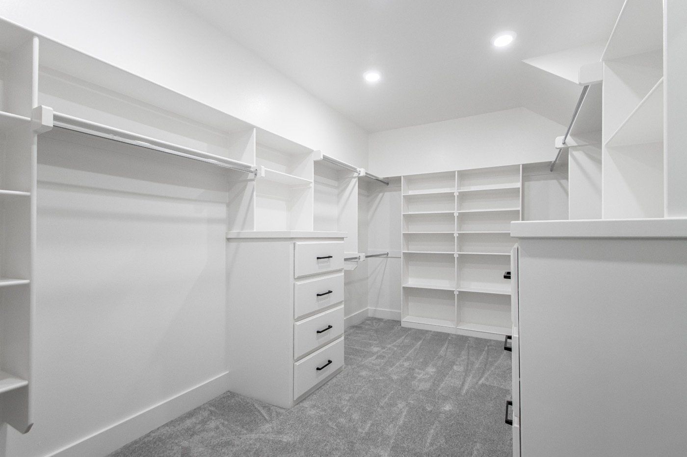 Spacious walk-in closet with custom shelving and hanging space.