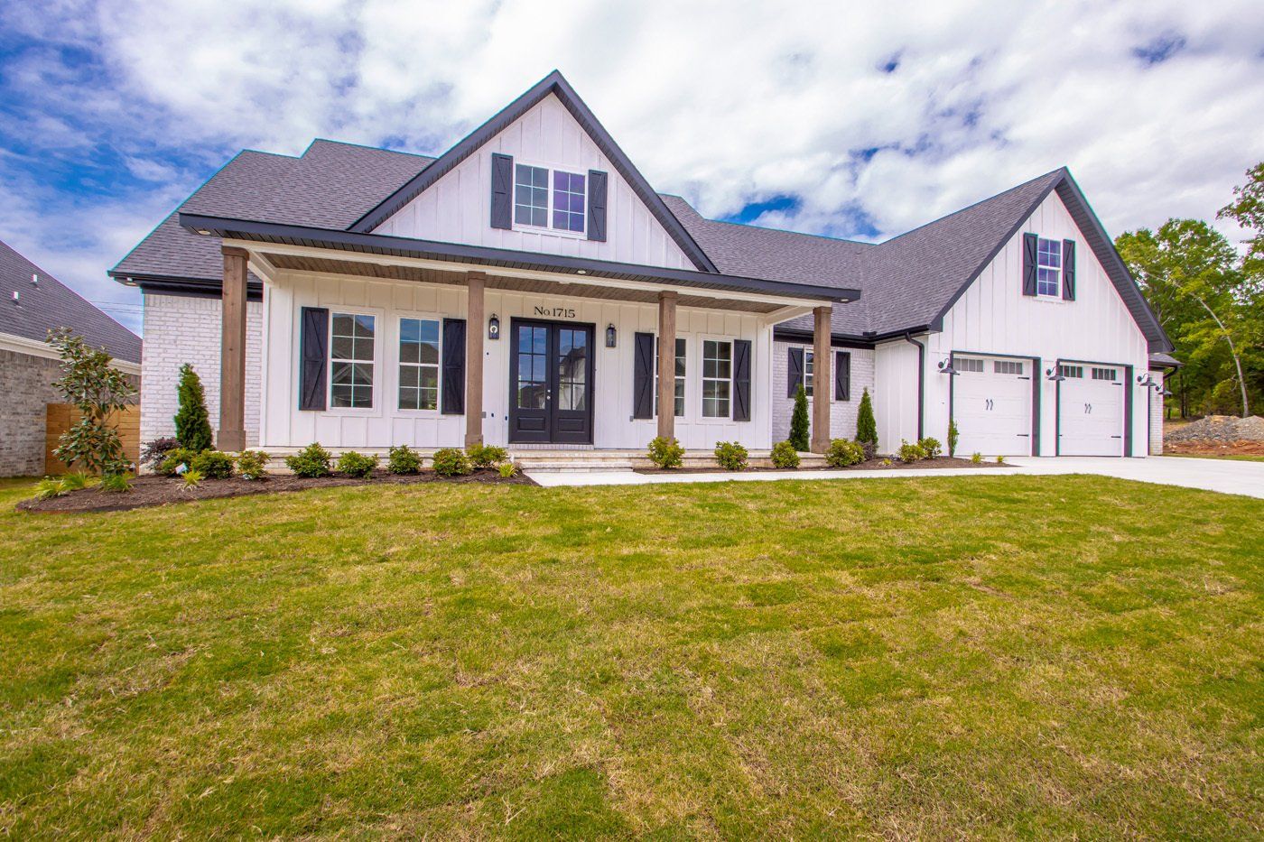 Front view of a finished custom-built home with large front porch.