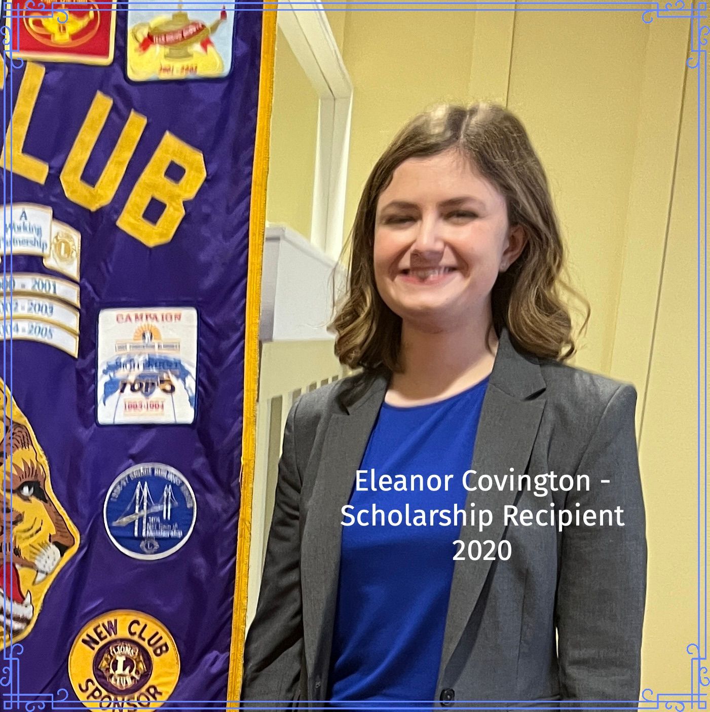 Eleanor Covington, smiling scholarship recipient, 2020. Wearing a blazer in front of a club banner.