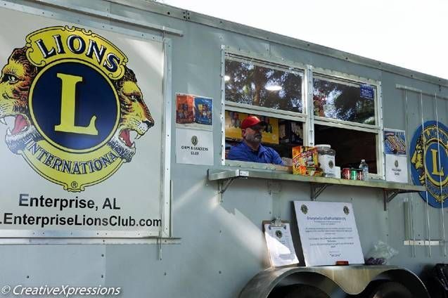 A Lions Club food trailer in Enterprise, AL, with a man serving food.