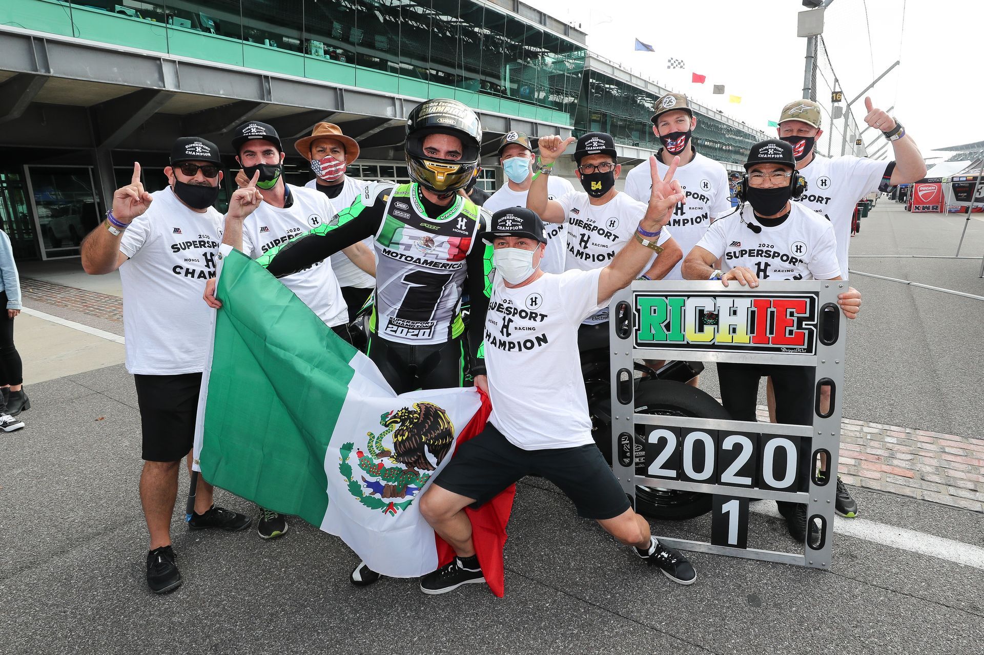 Race winner Pato O'Ward and his crew celebrate at Indianapolis Motor Speedway, waving the Mexican flag; 2020 victory.