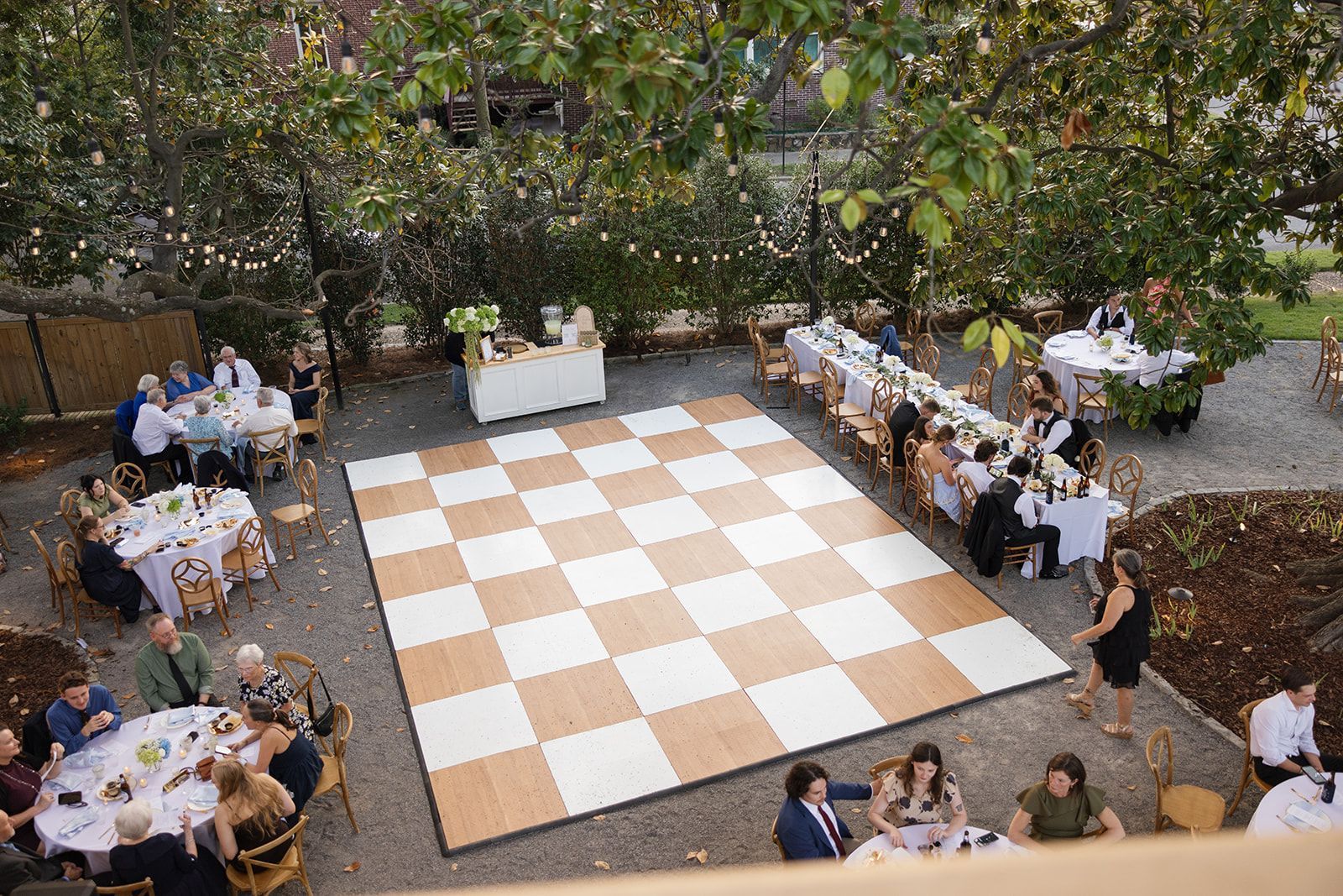 A E.O. Manees House lawn decorated with linen-covered tables and a checkered dance floor.