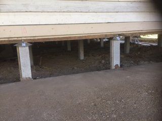 A house is being built on stilts underneath it.