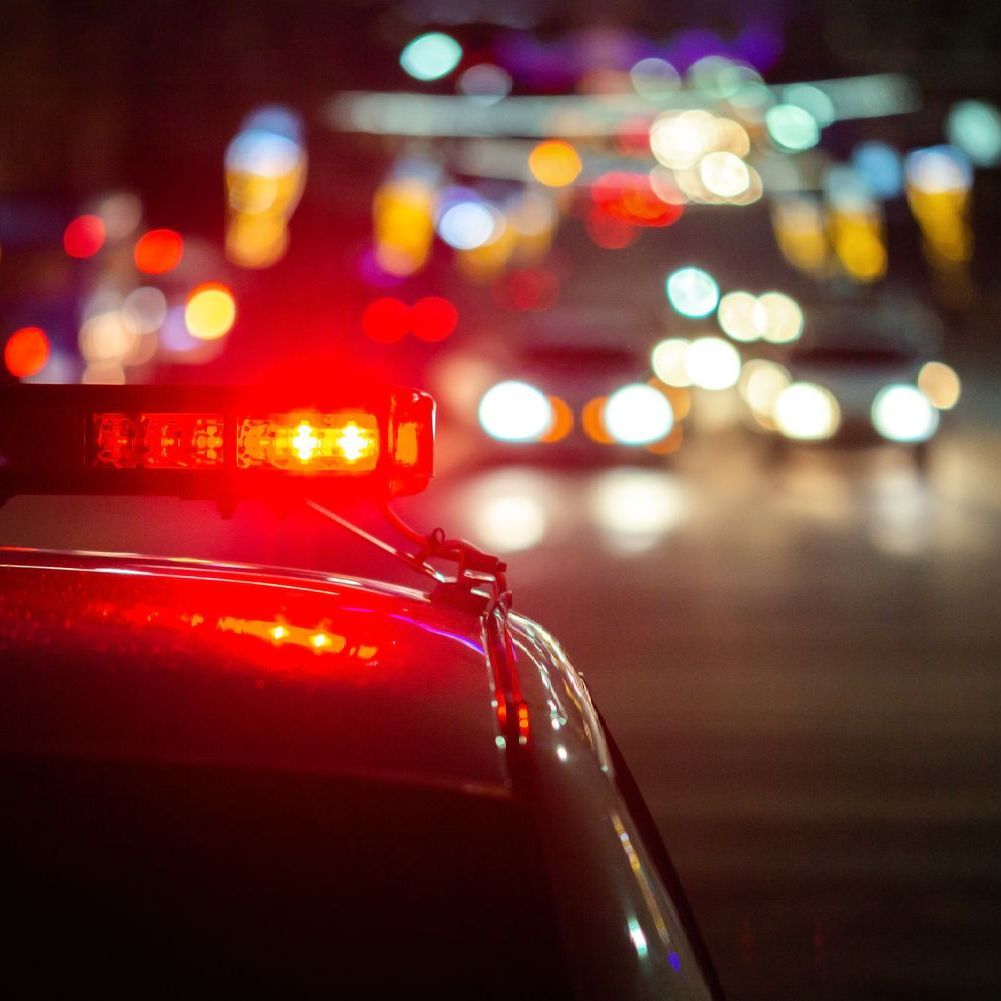 A close up of a police car with a red light on top of it.