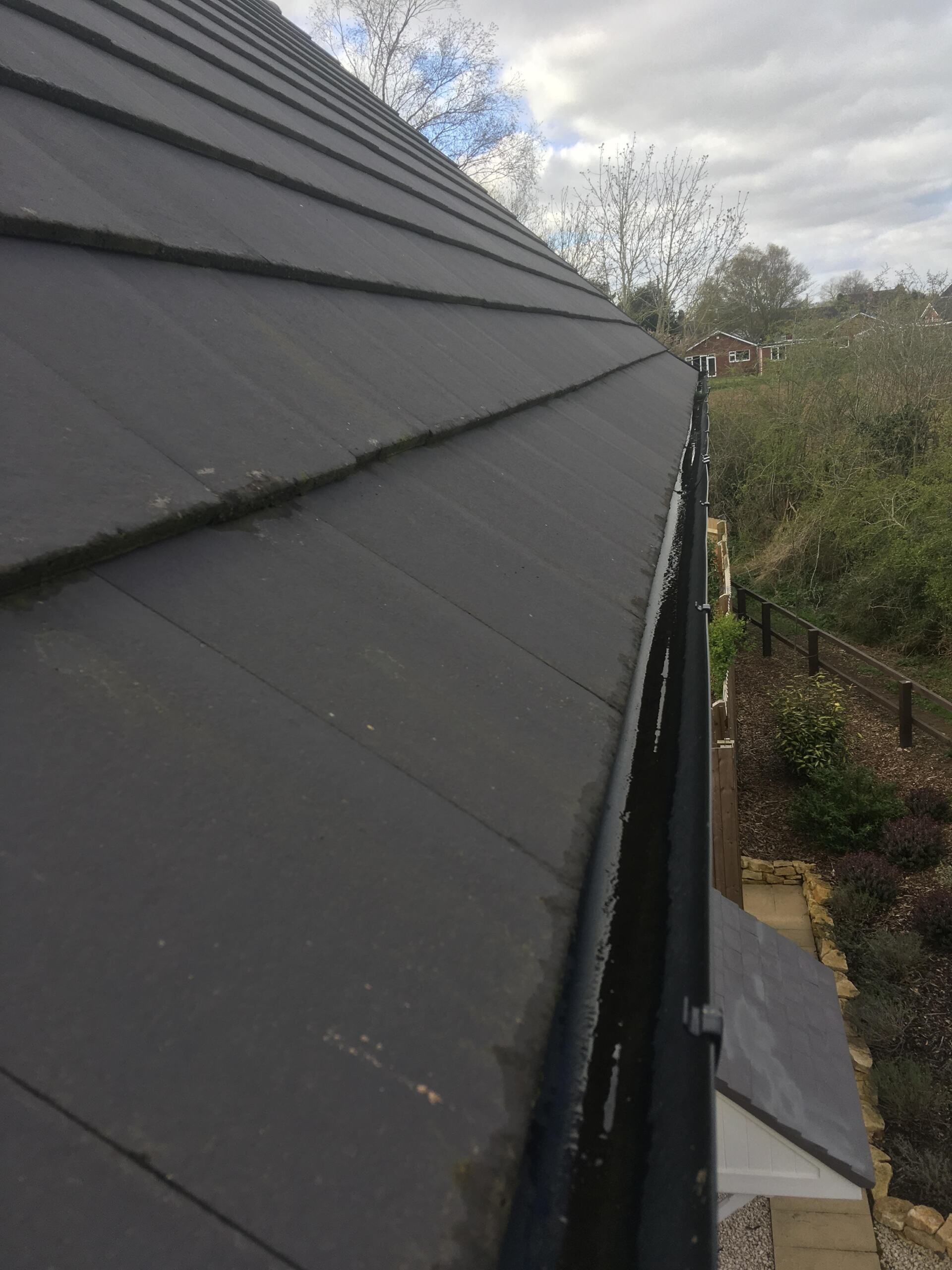 A close up of a roof with a gutter on it.