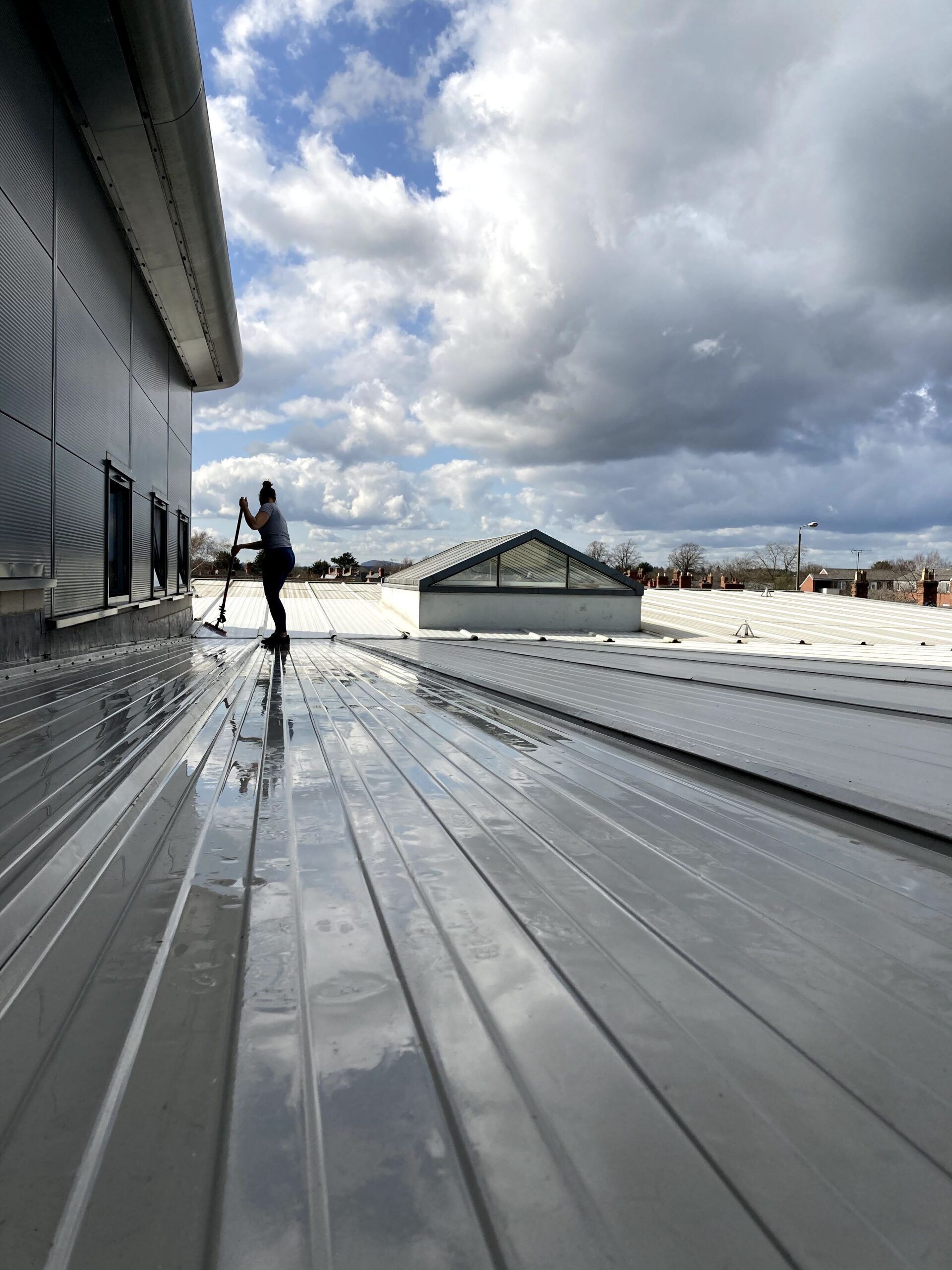 A man is standing on the roof of a building.