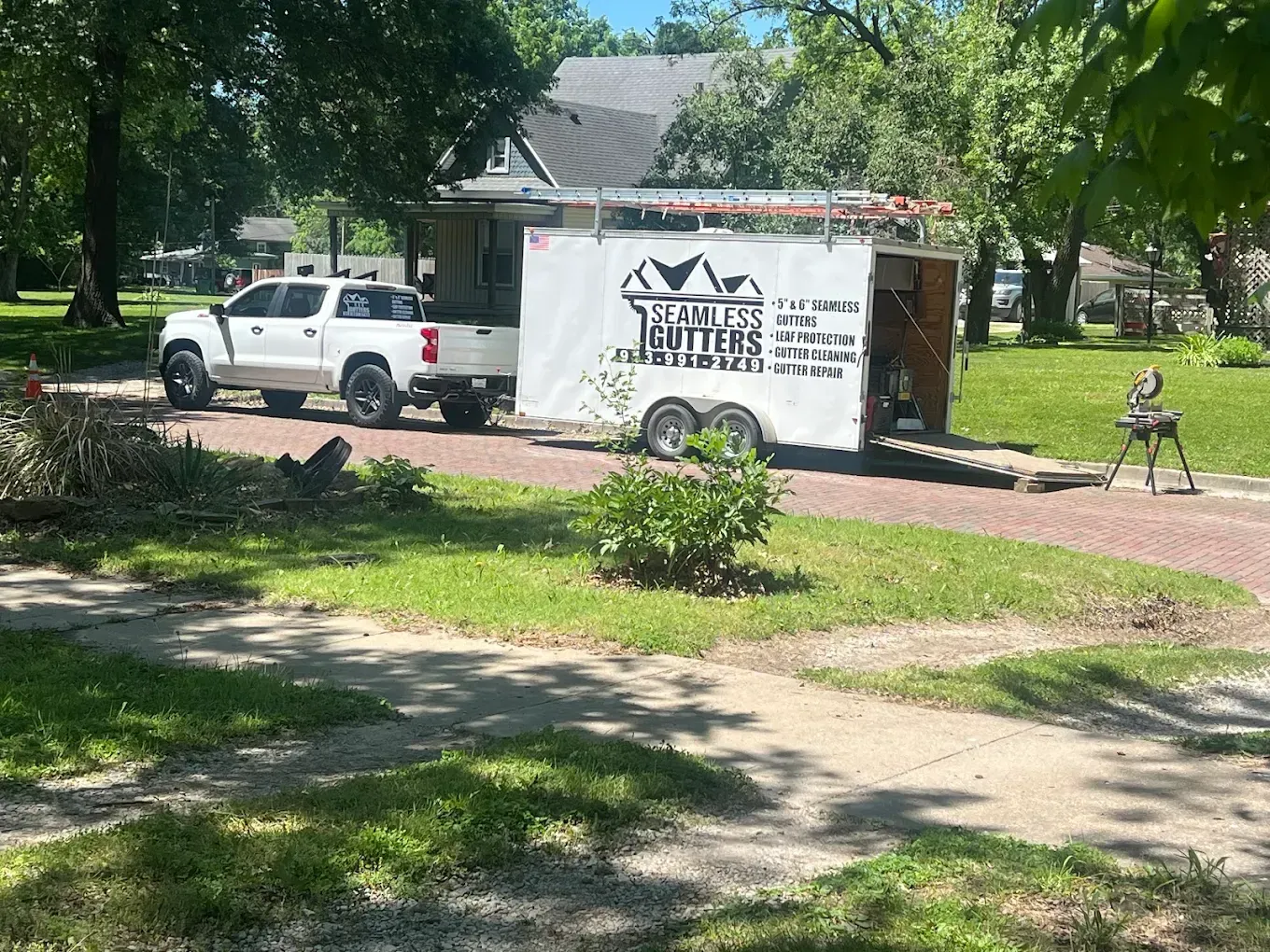 A white pickup truck pulling a trailer for 